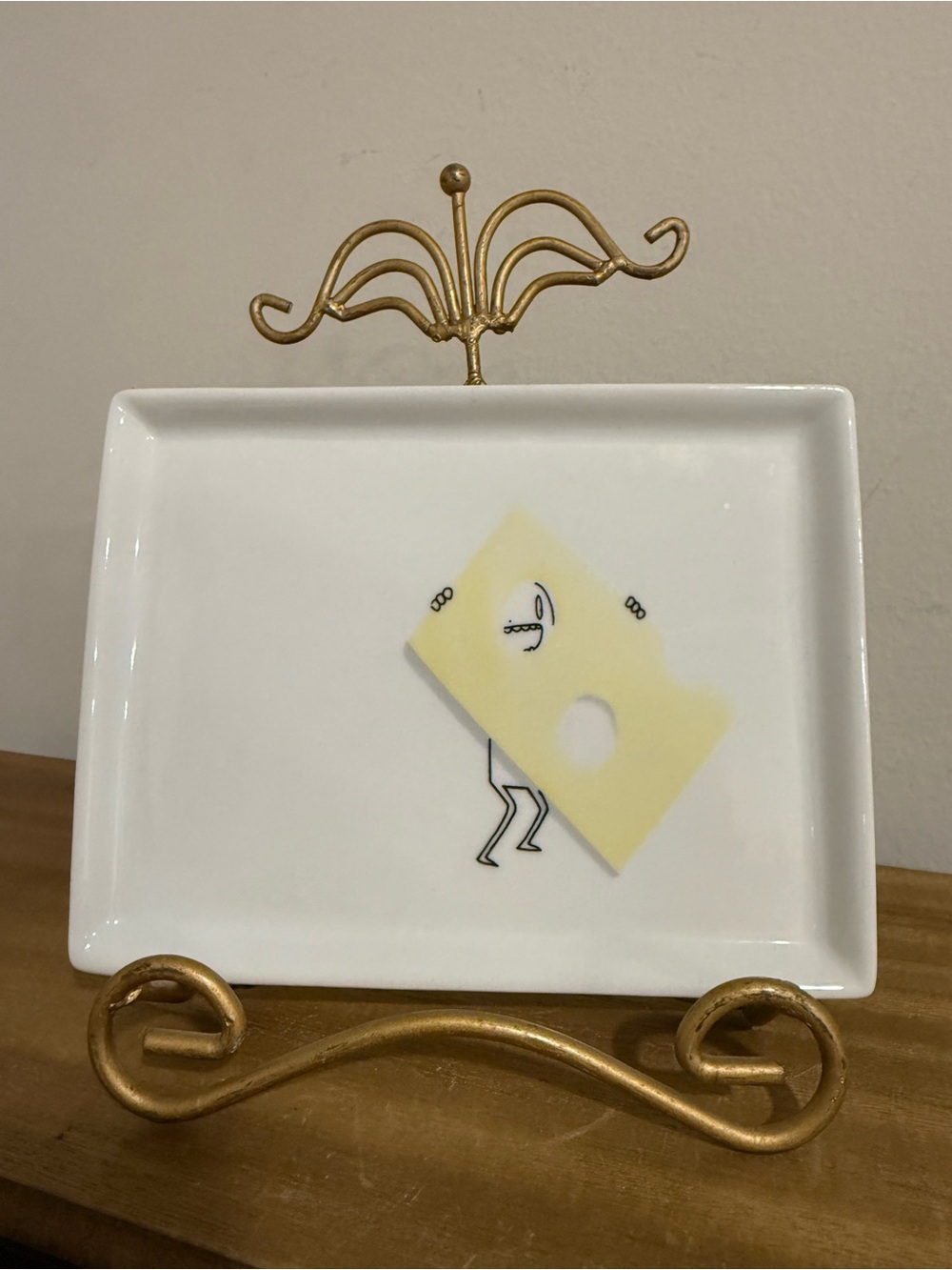 CB2 Oliver appetizer snack plate featuring a whimsical stick figure design